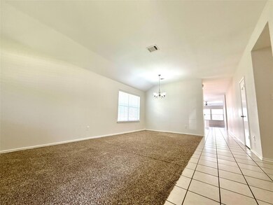 Empty room featuring a chandelier, lofted ceiling