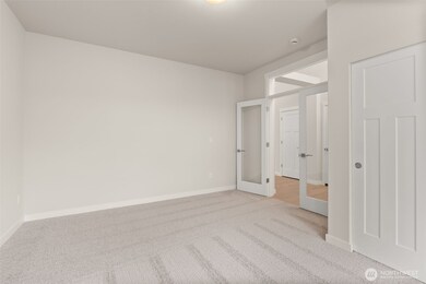 Off the front entry hall clear glass doors open into what could be a den/office space or a 3rd bedroom.