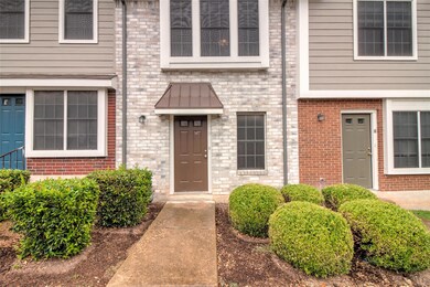 View of exterior entry with brick siding