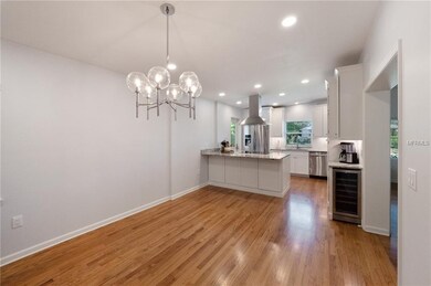 Dining room looking towards the kitchen - notice the upgraded lighting and custom wine fridge tucked into the cabinet on the right.
