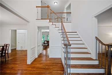 Stairway featuring wood finished floors