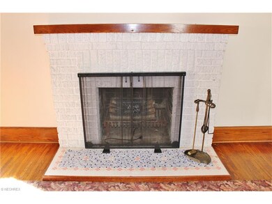 Brick fireplace with custom tile hearth.