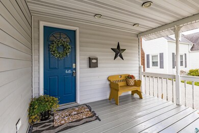 Entrance to property featuring covered porch