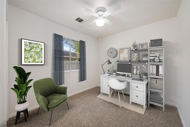 Office space with light colored carpet, a ceiling