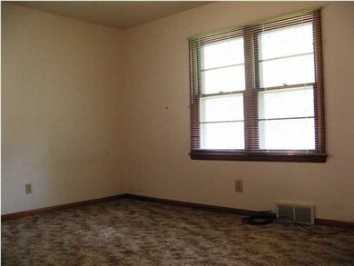 Master bedroom. Carpet has been pulled up in corne
