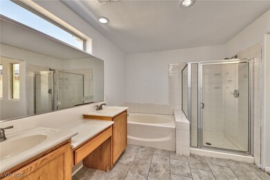 Bathroom with a garden tub, a sink, double vanity,