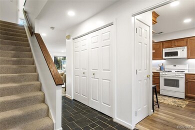 Entryway with dark slate tile floors and giant coa