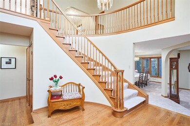 Grand, two-story Foyer features curved staircase