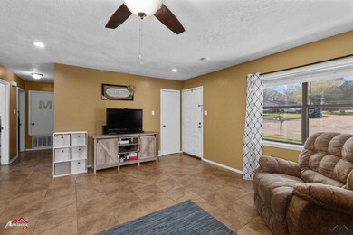 Living area featuring visible vents, baseboards, c