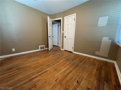 Unfurnished bedroom with dark hardwood / wood-style flooring