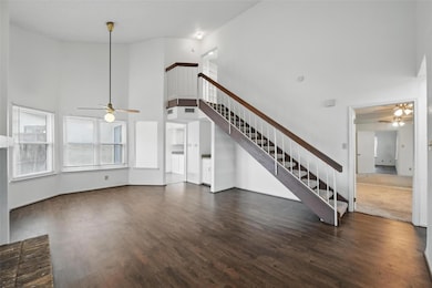 Unfurnished living room with stairway, a ceiling f