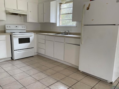 Kitchen featuring white cabinetry, white appliance
