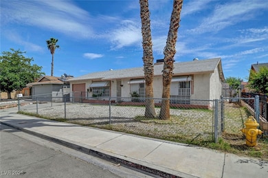 Ranch-style house with stucco siding, a fenced fro