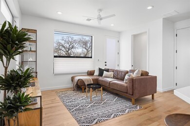 Living room with baseboards, ceiling fan, light w