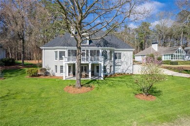 Back of house with a lawn and a patio area