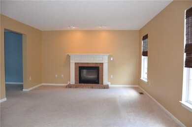 Spacious family room has brick surround fireplace