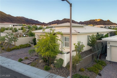 View of side of home featuring a mountain view, stucco siding, and a garage