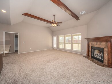 Large Family Room with plush carpet and beamed cei