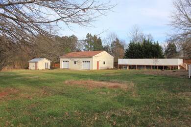 Massive three car detached garage as well as a smaller storage bldg. could be used as a possible room