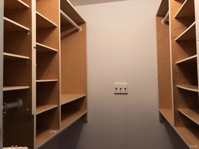 Master bedroom walk in closet with built in shelve