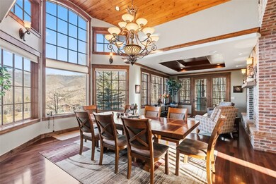 Dining area featuring a chandelier, wood finished floors, a mountain view, wood ceiling, and vaulted ceiling