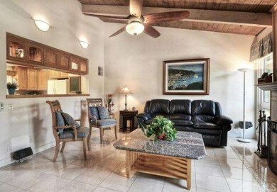 Family room with fireplace opens to kitchen
