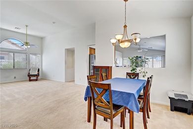Dining space featuring ceiling fan, light colored