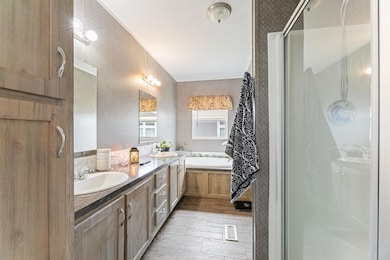 Full bath with a stall shower, wallpapered walls,