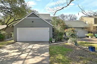 View of front facade with a garage and a shingled