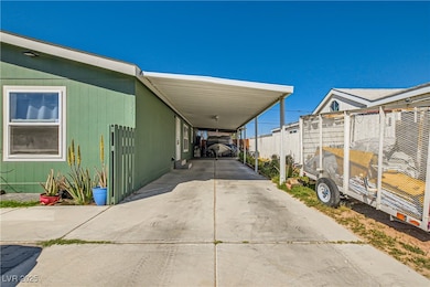 View of car parking featuring fence, an attached c