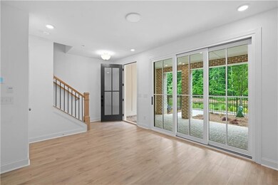 An elegant 4 panel glass door creates a striking entry to the media/flex room & a large sliding glass door fills the space with natural light and provides easy access to the outdoor patio, creating a seamless indoor-outdoor connection. Ideal for relaxing