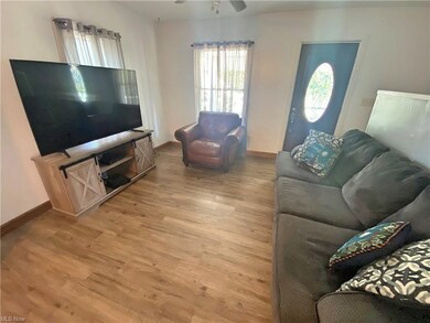 LIVING ROOM WITH NEWER FLOORING.