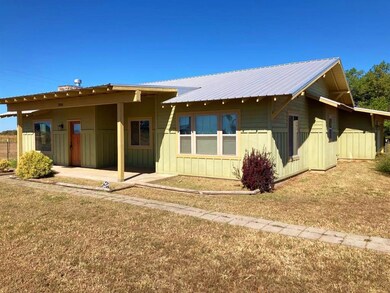Rear view of property with a lawn