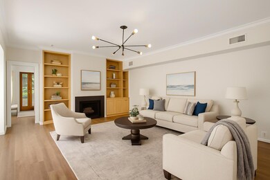 Living room with ornamental molding, light wood-s