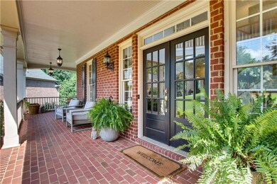An inviting wrap-around front porch creates a welcoming first impression.