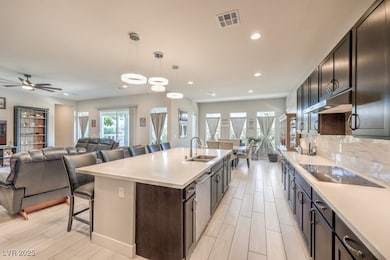 Kitchen featuring a sink, black electric stovetop,