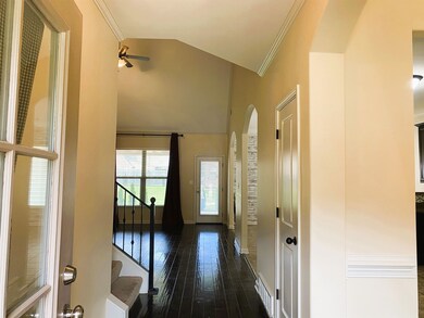 Corridor featuring ornamental molding and dark har
