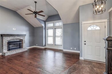 Great room with fiireplace and vaulted ceiling.