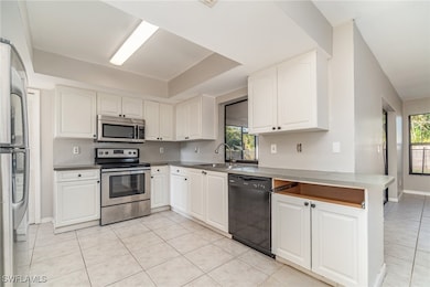 Kitchen featuring white cabinets, a healthy amount