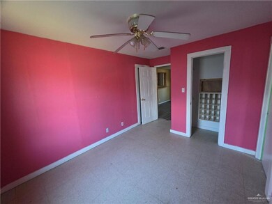Unfurnished bedroom featuring tile patterned floors and ceiling fan