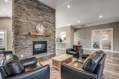 Featuring a stone fireplace and hardwood / wood-st