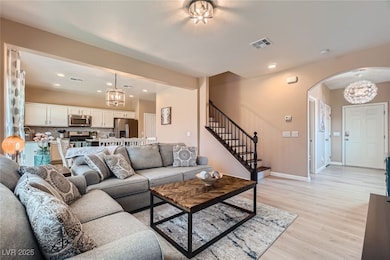 Living area featuring arched walkways, light wood-