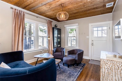 Living area featuring wooden ceiling, hardwood / 