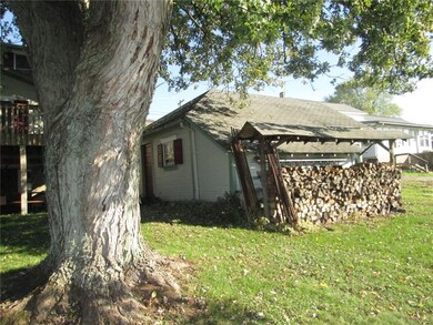 Mature maple graces the back yard, fire wood so th