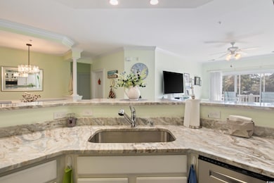 Kitchen with crown molding, a sink, ceiling fan, dishwasher, and light stone countertops
