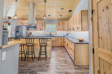 Kitchen featuring pendant lighting, dark wood-type