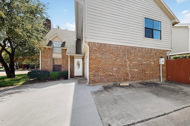 View of front facade with brick siding and a chimney