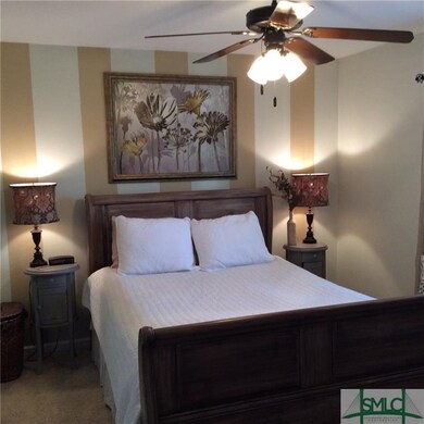 Cheeful master suite with ceiling fan and walk in 