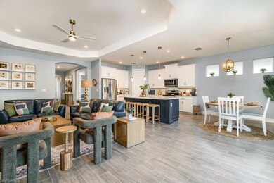 Living room featuring ceiling fan with notable cha