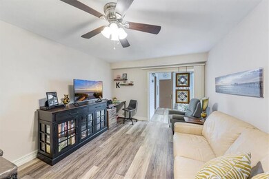 Living area with wood finished floors and ceiling fan